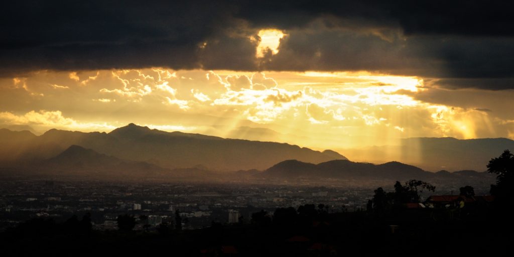 Bright light shining through the clouds representing the light of god